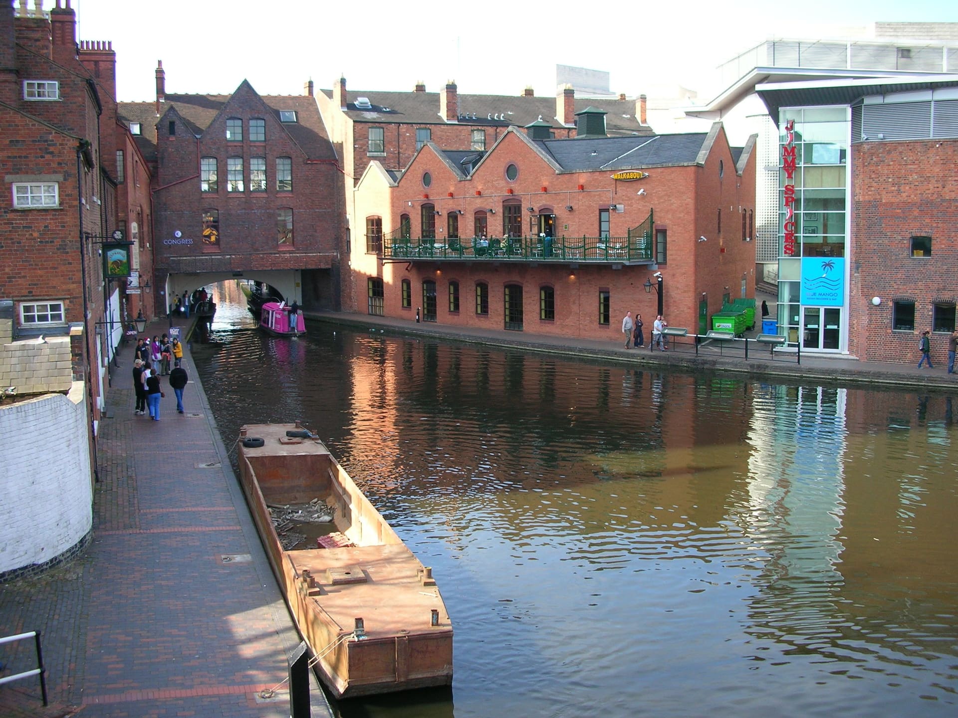 The Gas Street Basin canal in Birmingham, warehouses reflected in still water.