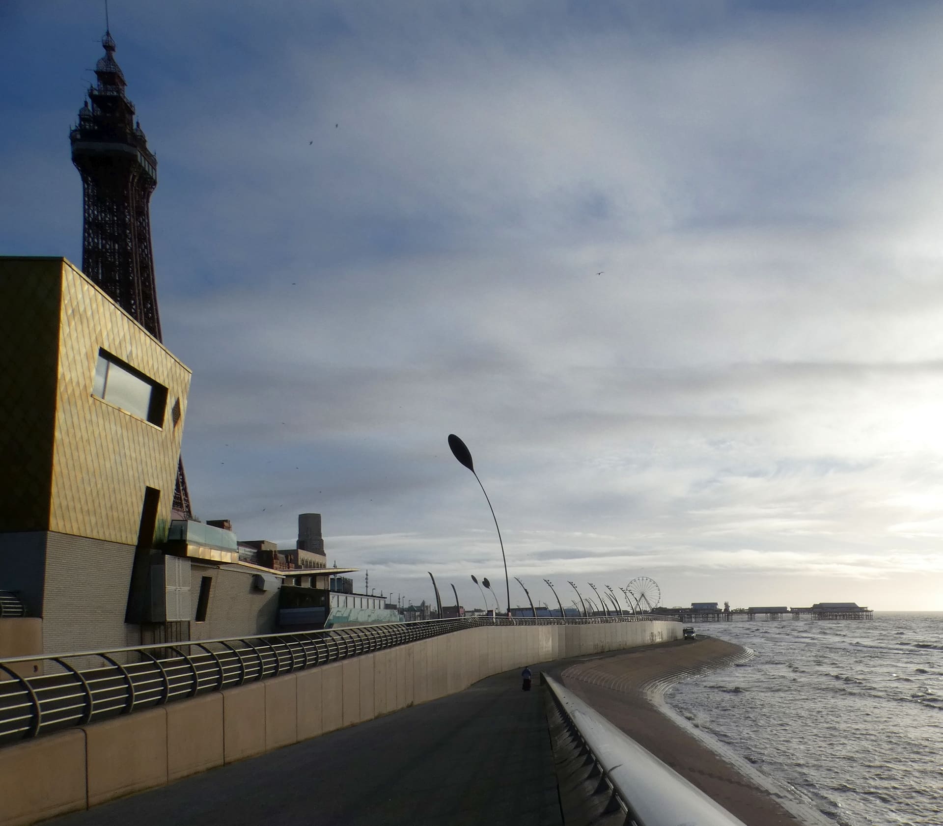 Blackpool's promenade curving south from the North Pier at dusk.