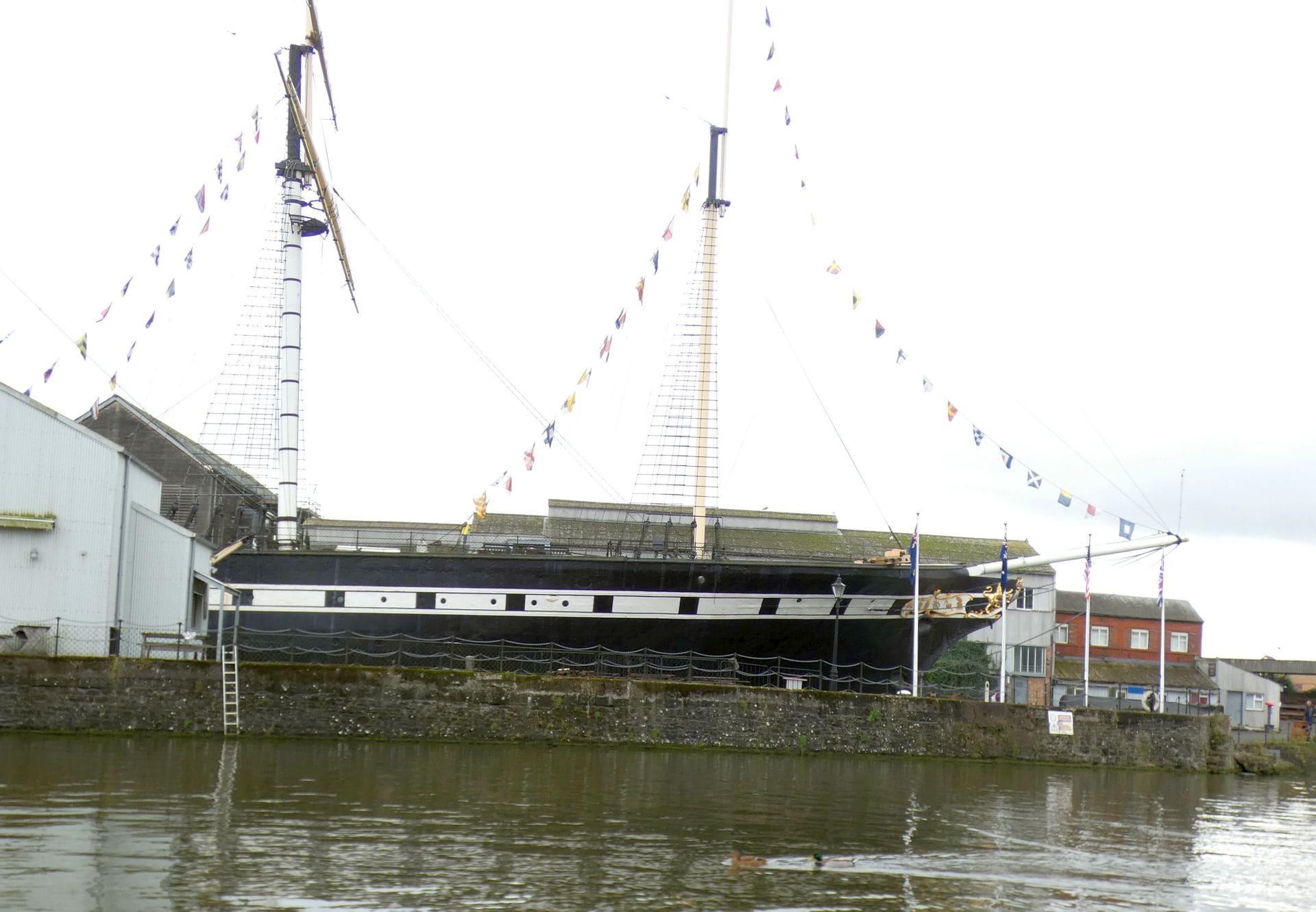 The masts and hull of the SS Great Britain in Bristol's floating harbour.