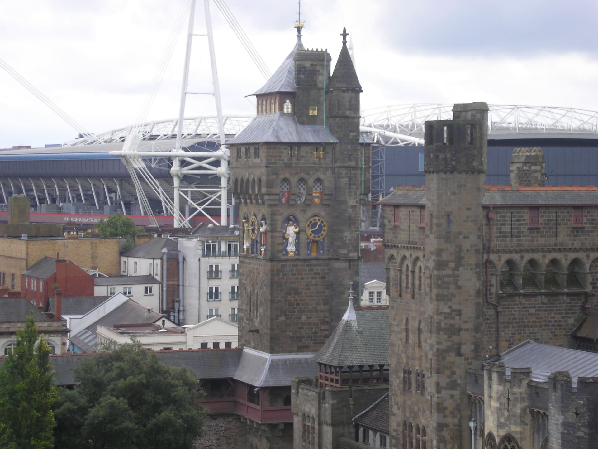 The clock tower of Cardiff Castle with the stadium roof behind it.