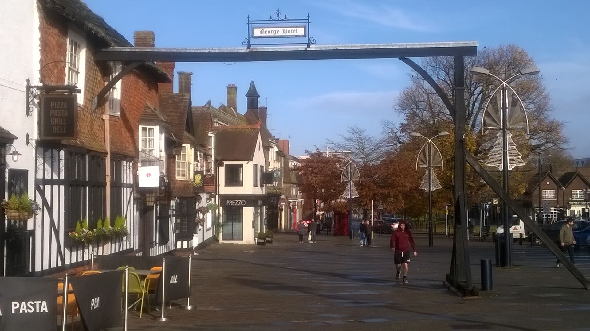 The gallows sign of the George Hotel spanning Crawley High Street.