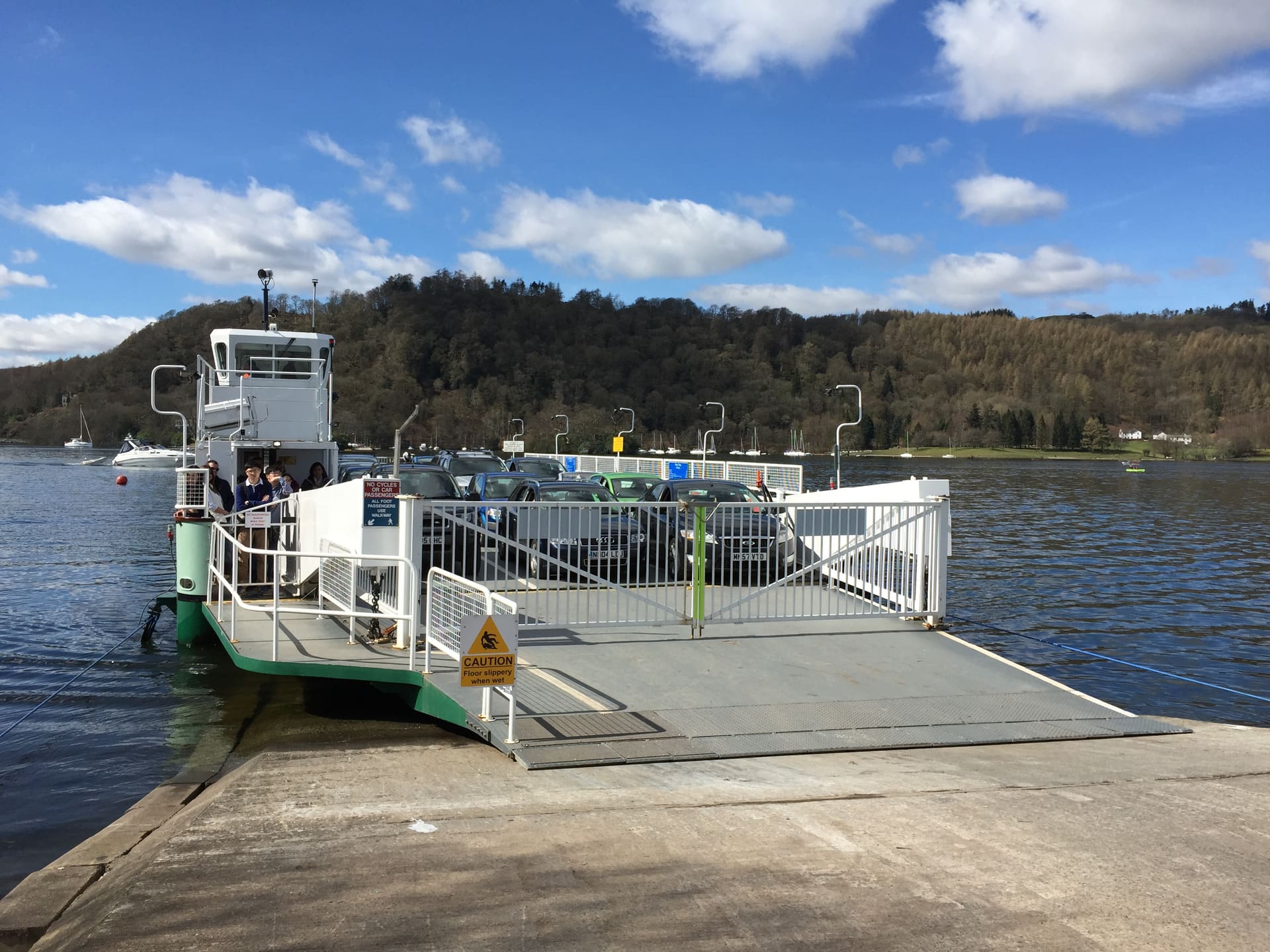 The Windermere car ferry crossing beneath wooded fells.