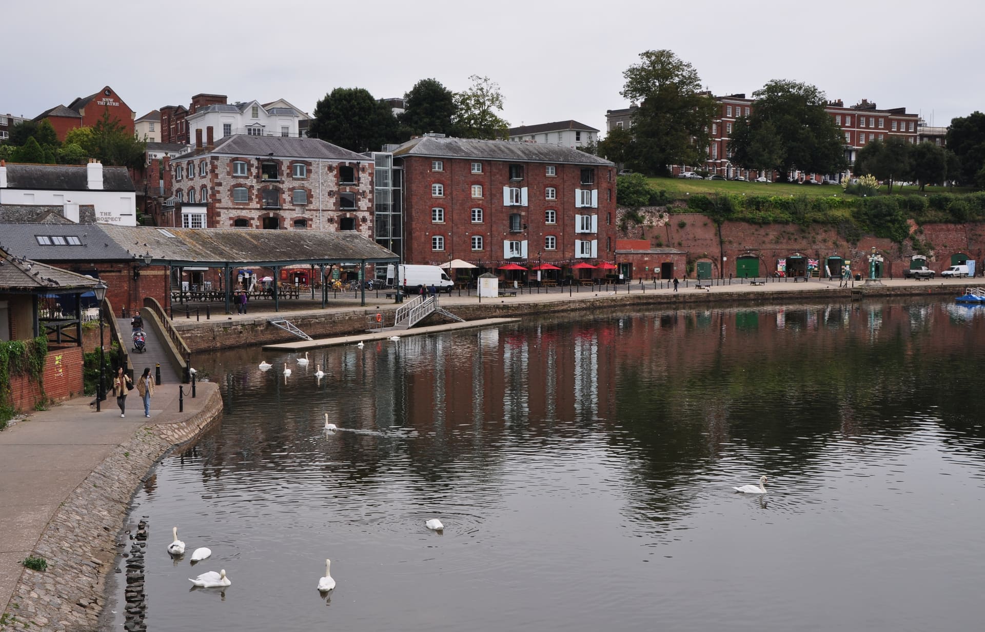Warehouses and swans on the River Exe at Exeter's quay.