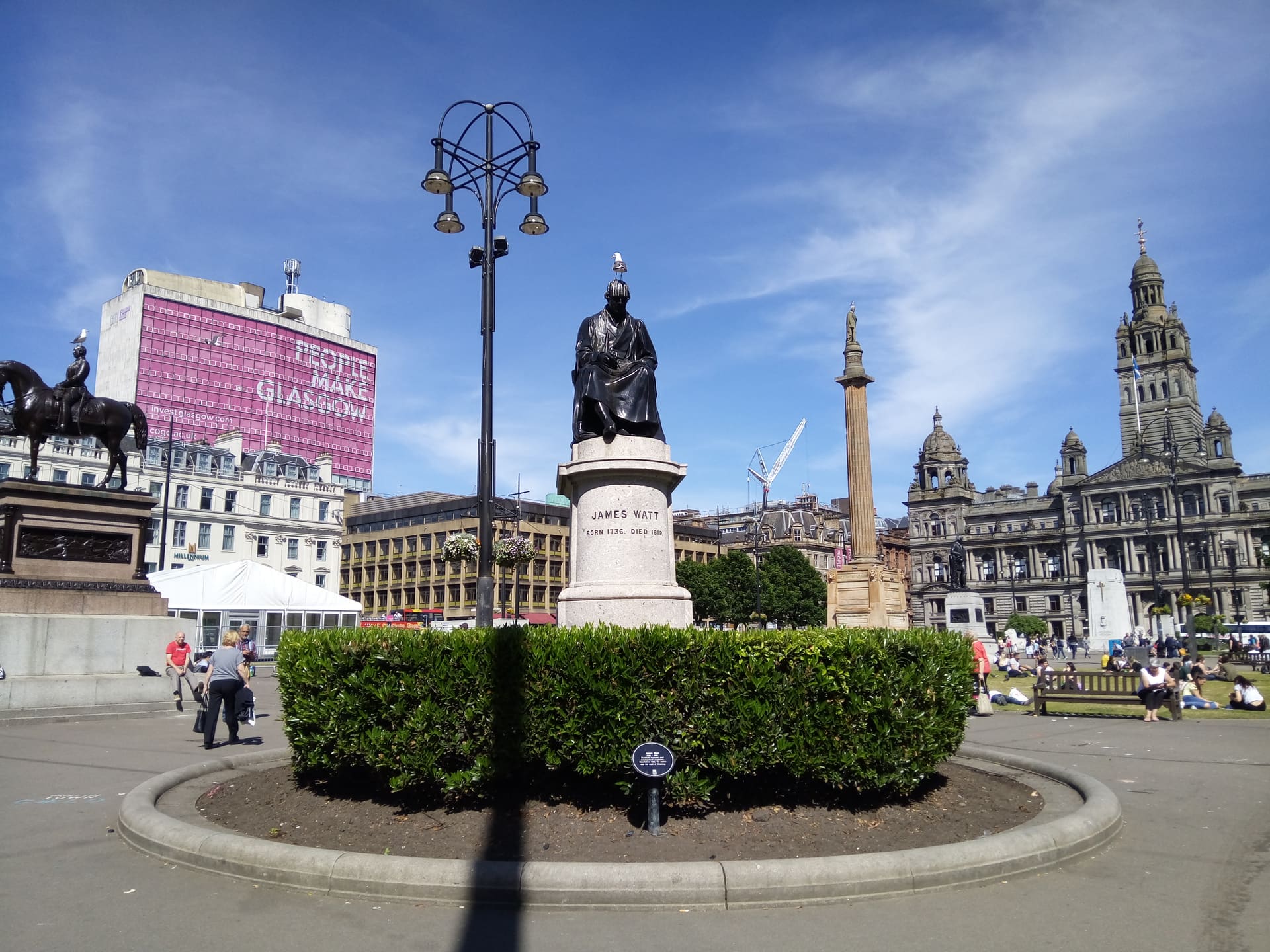 George Square's statues and the City Chambers in Glasgow.