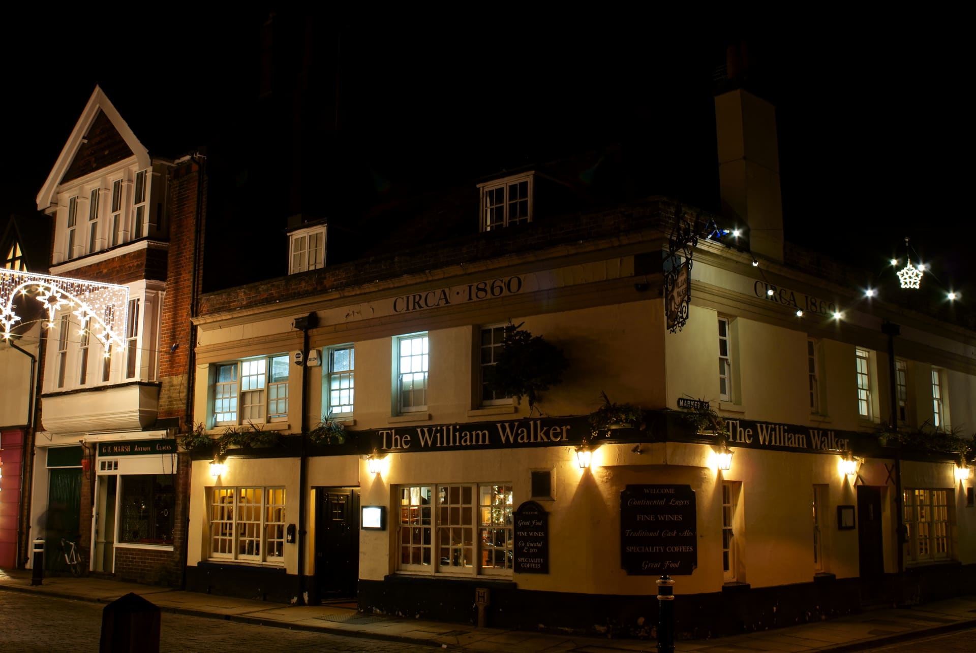 The William Walker public house lit at night in Winchester.