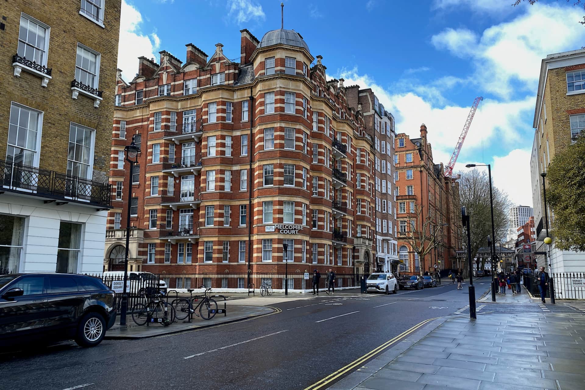 Red-brick mansion blocks rising over a Marylebone street.