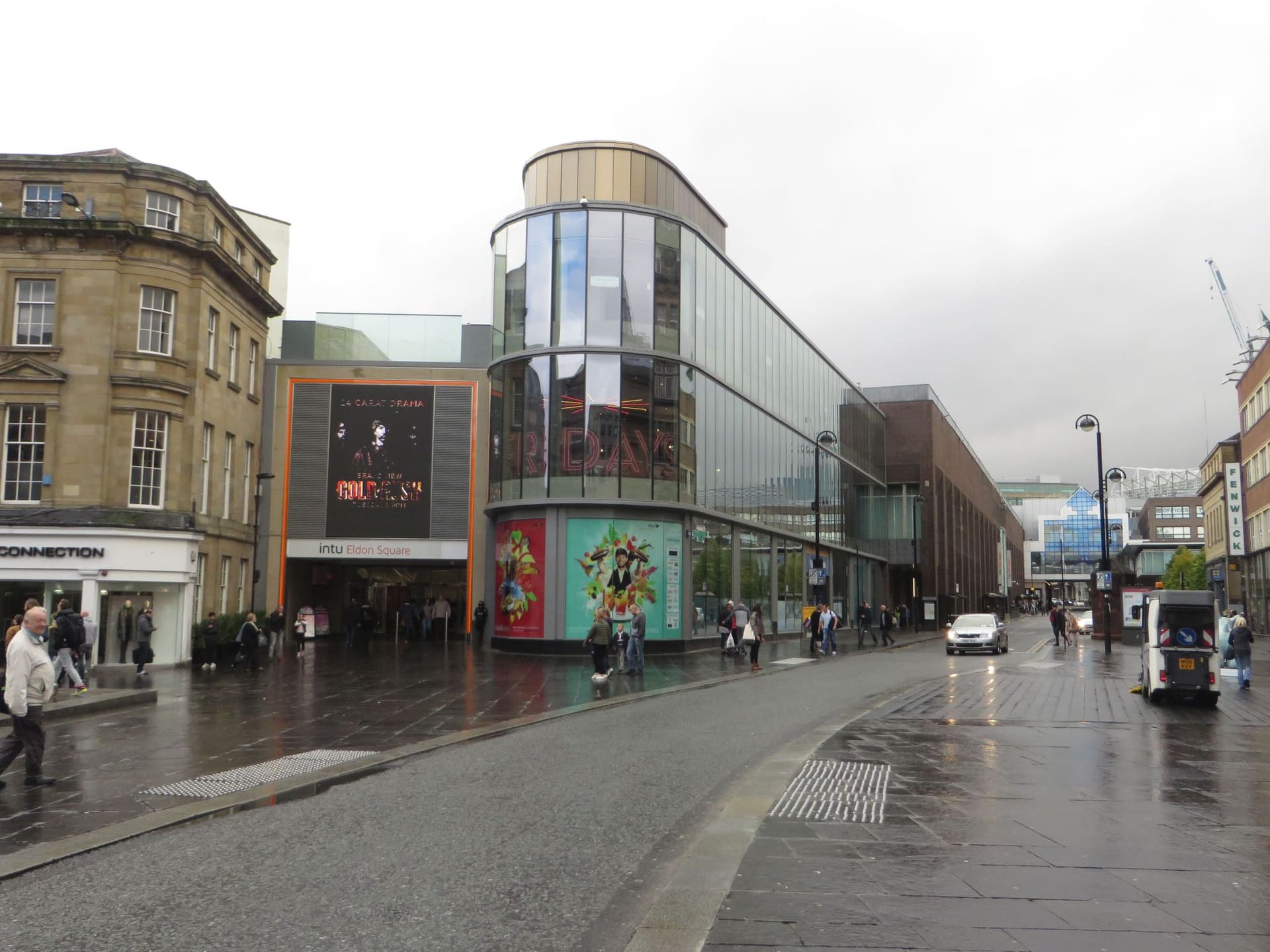 Blackett Street and the curved glass of Eldon Square on a wet day in Newcastle.