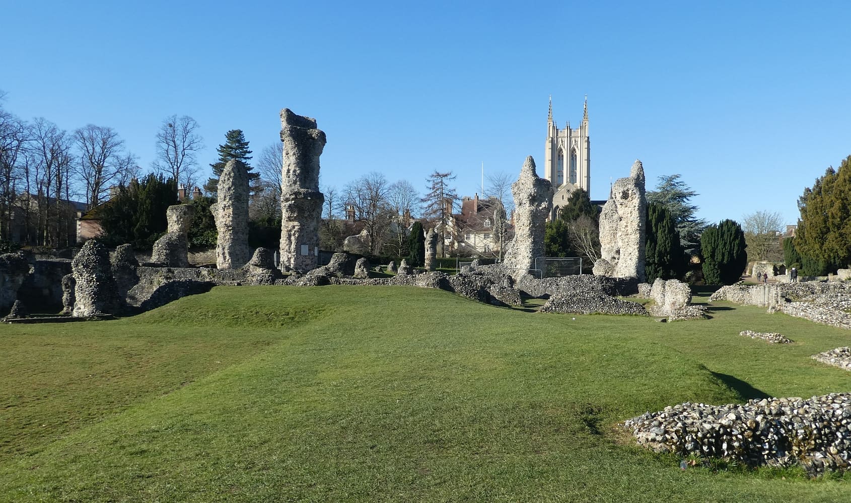 The abbey ruins and cathedral tower across the green at Bury St Edmunds.